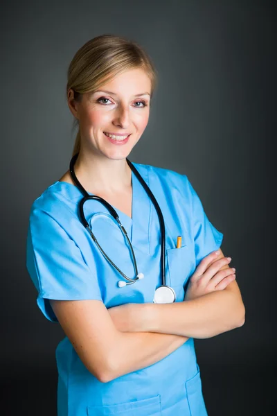 Woman in medical doctor uniform holding clipboard Royalty Free Stock Images