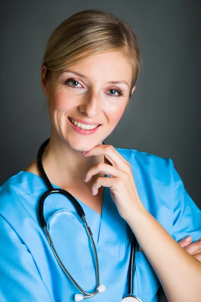 Woman in medical doctor uniform holding clipboard Royalty Free Stock Images
