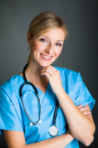 Woman in medical doctor uniform holding clipboard Stock Image