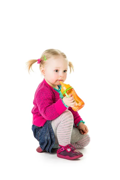 Meisje van de baby het drinken van thee uit fles — Stockfoto