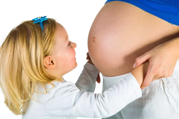 Pregnant woman with 2 yo daughter on white — Stock Photo, Image