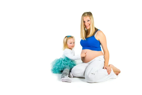 Pregnant woman with 2 yo daughter on white — Stock Photo, Image