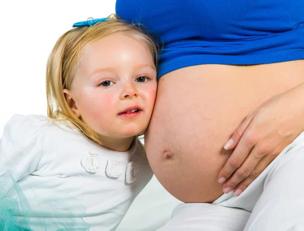 Pregnant woman with 2 yo daughter on white — Stock Photo, Image