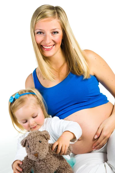 Pregnant woman with 2 yo daughter on white — Stock Photo, Image