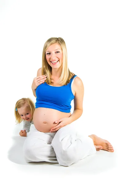 Pregnant woman with 2 yo daughter on white — Stock Photo, Image