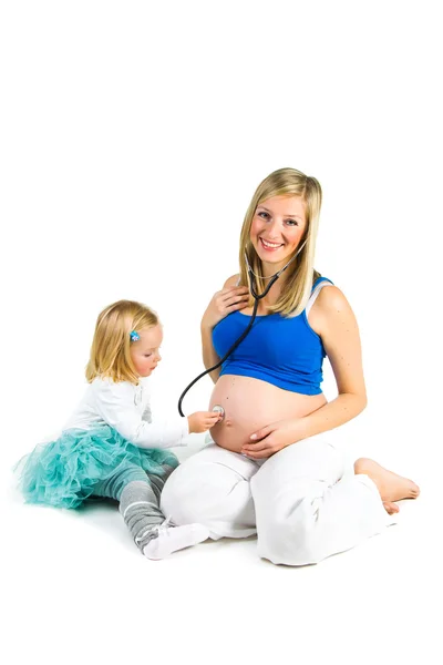 Pregnant woman with 2 yo daughter on white — Stock Photo, Image