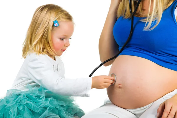 Pregnant woman with 2 yo daughter on white — Stock Photo, Image