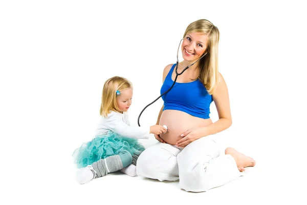 Pregnant woman with 2 yo daughter on white — Stock Photo, Image