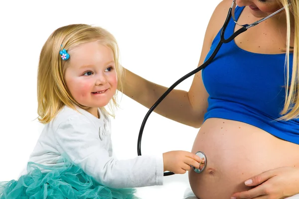 Pregnant woman with 2 yo daughter on white — Stock Photo, Image