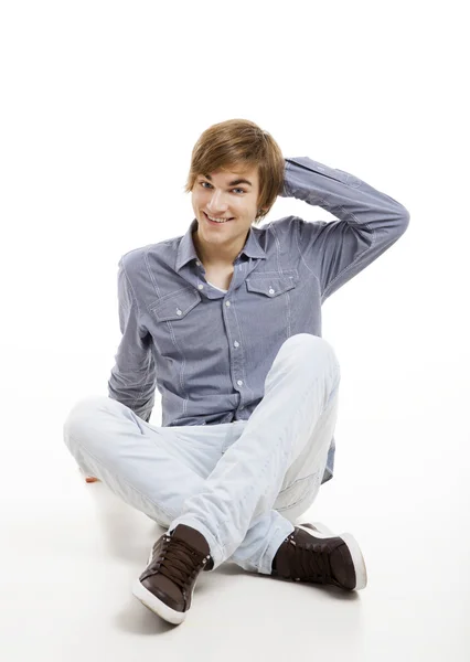 Young man sitting on the floor — Stock Photo, Image