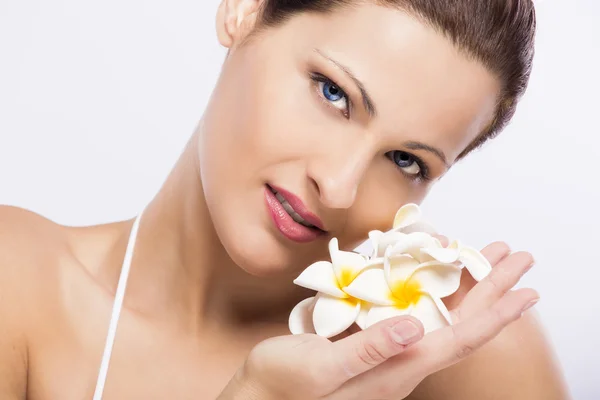 Beautiful woman holding flowers Stock Photo