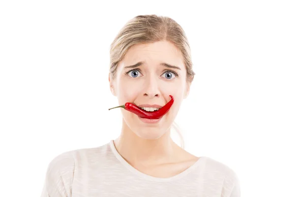 Woman with a silly face holding a red chilli pepper — Stock Photo, Image