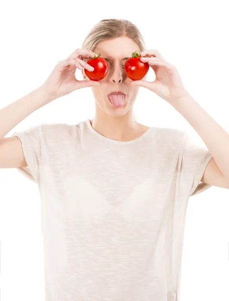 Mulher beaitiful com tomates na frente do rosto — Fotografia de Stock