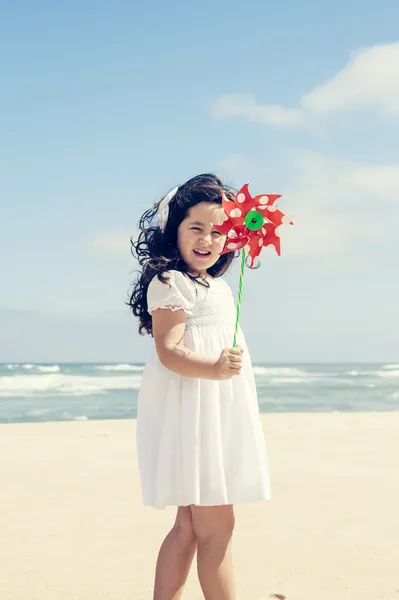 Little girl with a windmill — Stock Photo, Image