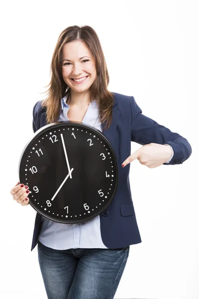 Donna d'affari in possesso di un grande orologio Fotografia Stock