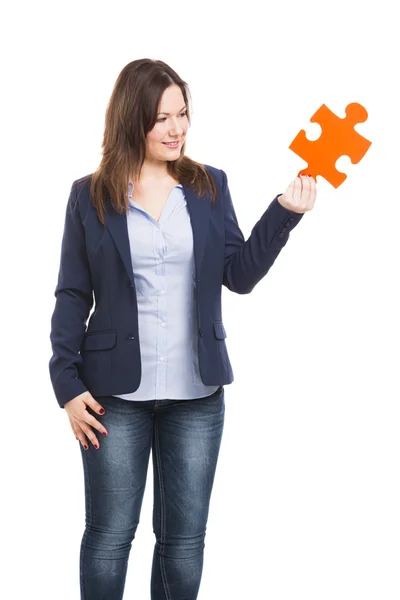 Business woman holding a puzzle piece — Stock Photo, Image