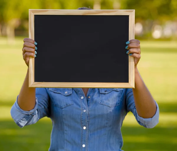 Holding a shalkboard — Stock Photo, Image