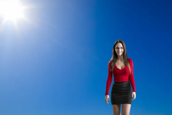 Beautiful woman against a blue sky — Stock Photo, Image