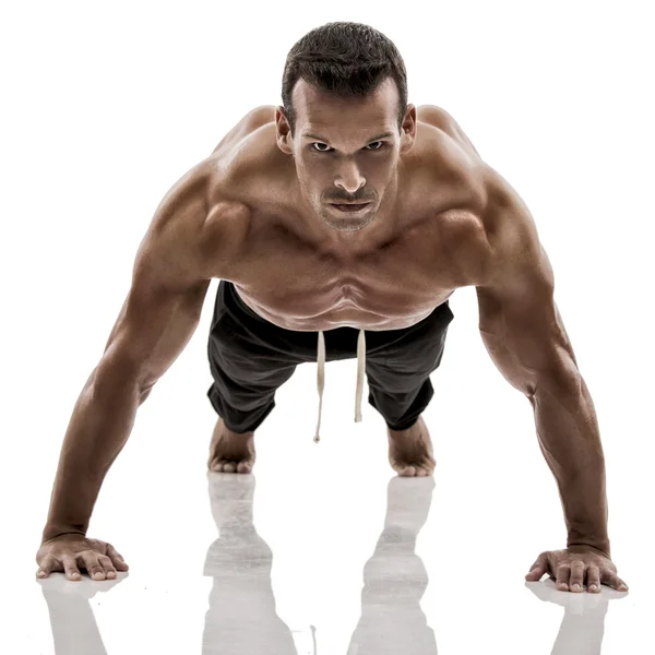 Muscle man making pushups — Stock Photo, Image