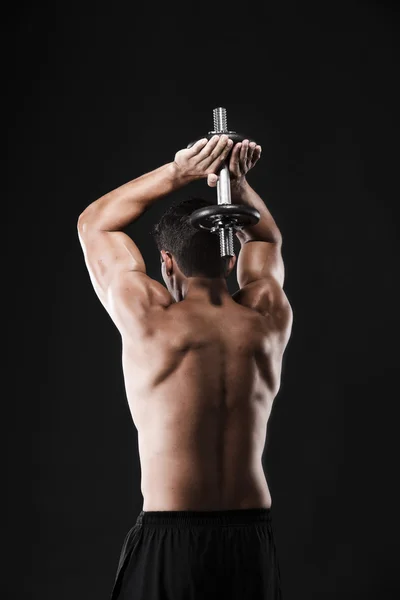 Muscular man lifting weights — Stock Photo, Image