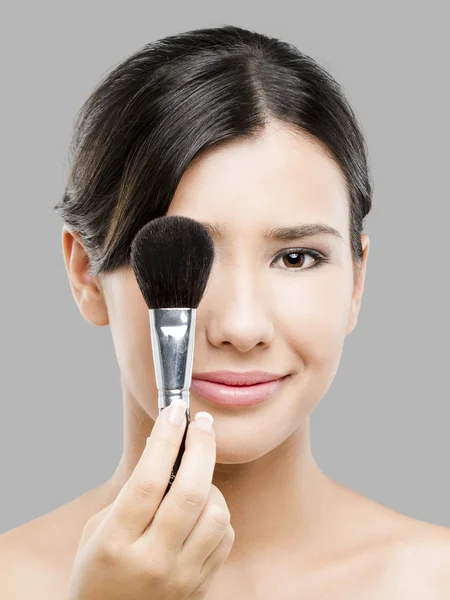 Beautiful Asian woman with make-up brushes — Stock Photo, Image