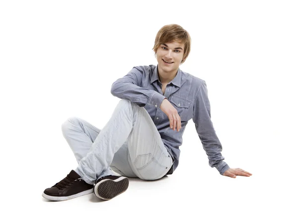 Young man sitting on the floor — Stock Photo, Image