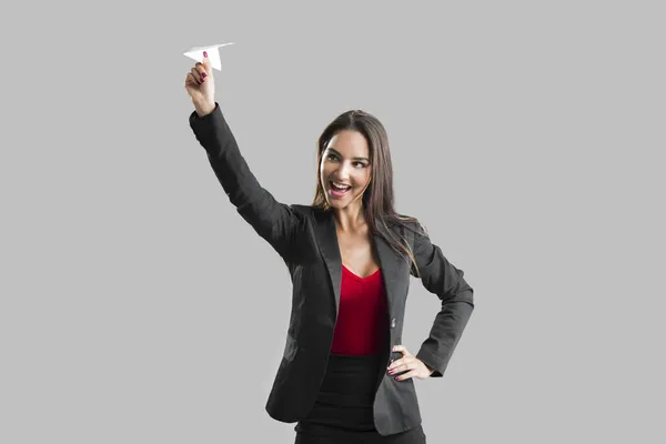 Woman throwing a paper plane — Stock Photo, Image
