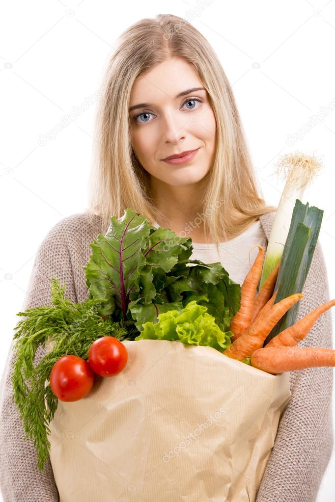 Woman carrying bag of vegetables