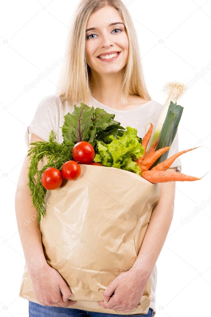 Woman carrying bag of vegetables