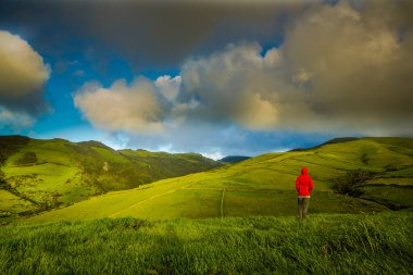 Woman in the top of a hill comtemplating the beauty of nature, Azores Island. clipart