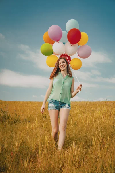 Young Woman Field Holding Colorful Balloons — Zdjęcie stockowe