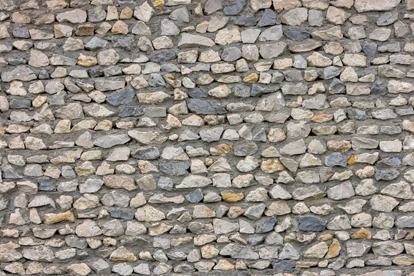 Бесшовная текстура уродливой острой каменной стены с бетоном между скалами — стоковое фото