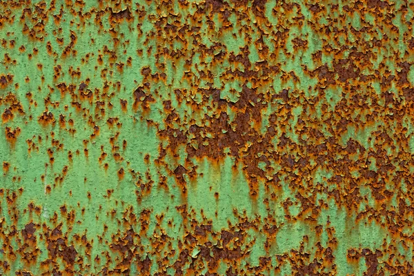 Peeled off green paint on flat rusted sheet metal surface — Stock Photo, Image