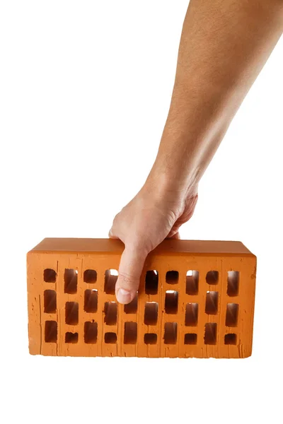 Bare caucasian hand holding orange perforated clay brick - isolated — Stock Photo, Image