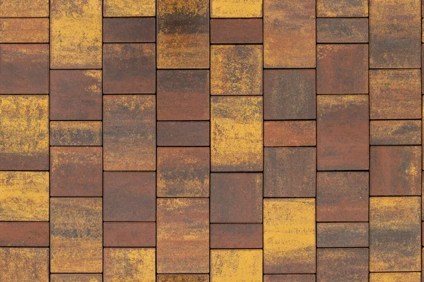 Textura sin costuras y fondo de marrón y amarillo melange rectangular pavimento de piedra artificial —  Fotos de Stock