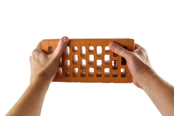 Two bare caucasian hands holding orange perforated clay brick - isolated on white — Stock Photo, Image