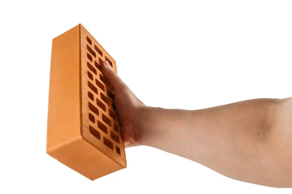 Bare caucasian hand holding orange perforated clay brick - isolated — Stock Photo, Image