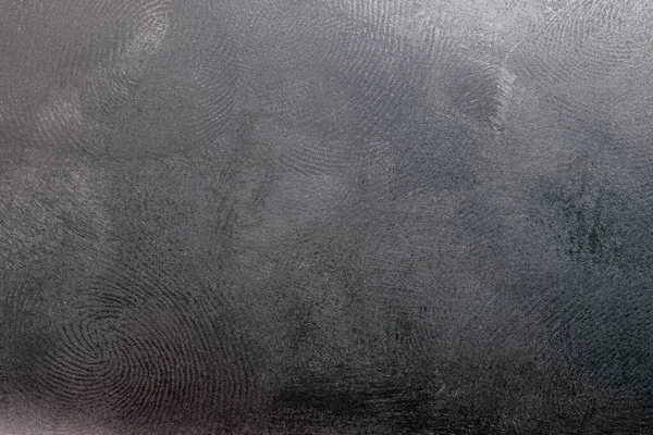 Чорна пластикова поверхня з декількома відбитками пальців, макро фото — стокове фото