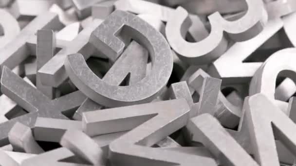 Full frame close-up looped rotating background of silver metal letters — Stock Video