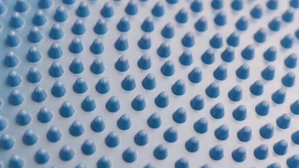 Looped slowly spinning blue rubber spikes on massager or balance disk — Stock Video