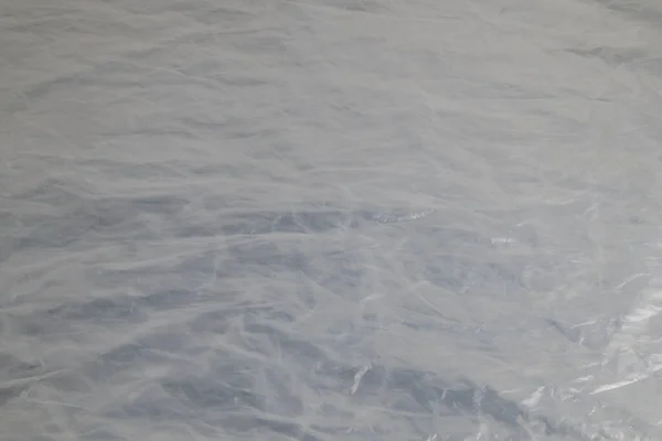 Hela ram bakgrund av platta skrynkliga semi-transparent polyetylen film — Stockfoto