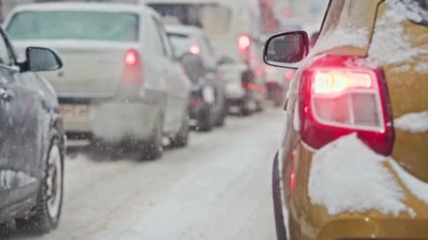 Χιόνι που καλύπτεται αυτοκίνητο πίσω φως κατά τη χειμερινή ημέρα στην κυκλοφορία κατά τη διάρκεια χιονόπτωση — Αρχείο Βίντεο