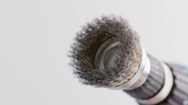 Hand drill with round steel brush spinning on white background — Stock Video