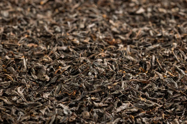 Teljes keret háttér lapos halom száraz hosszú távú fekete tea — Stock Fotó