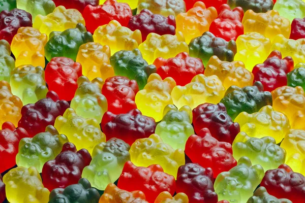 Sfondo full-frame di orsi gelatina colorati posati da vicino sulla superficie piana — Foto Stock