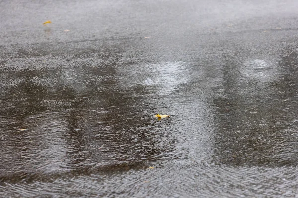 Asphalt road under rainfall or drizzle with fast shutter speed — Stock Photo, Image