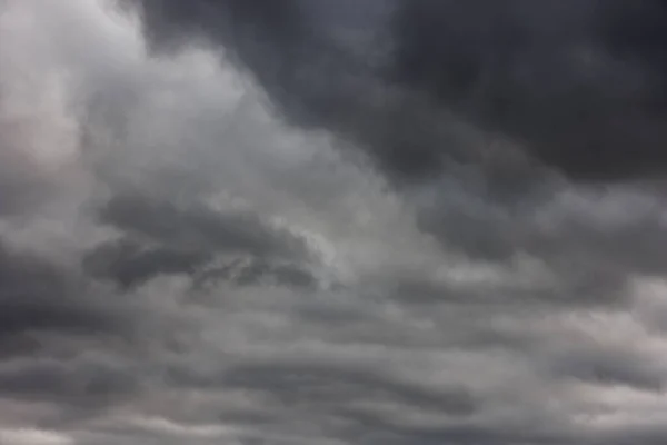 Abstract full-frame background of overcast sky with solid cover of grey clouds — 스톡 사진