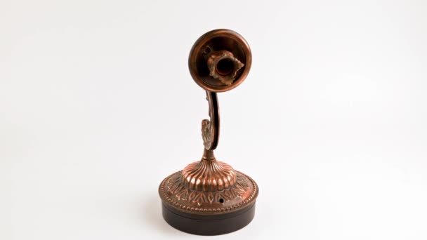 Fake bronze sconce spinning on turning table on white background — Video