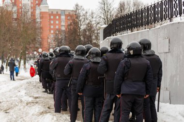 Public meeting in support of Navalny, police officers in black helmets wait for the command to arrest the protesters.