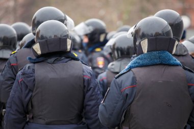 Public meeting in support of Navalny, police officers in black helmets wait for the command to arrest the protesters.